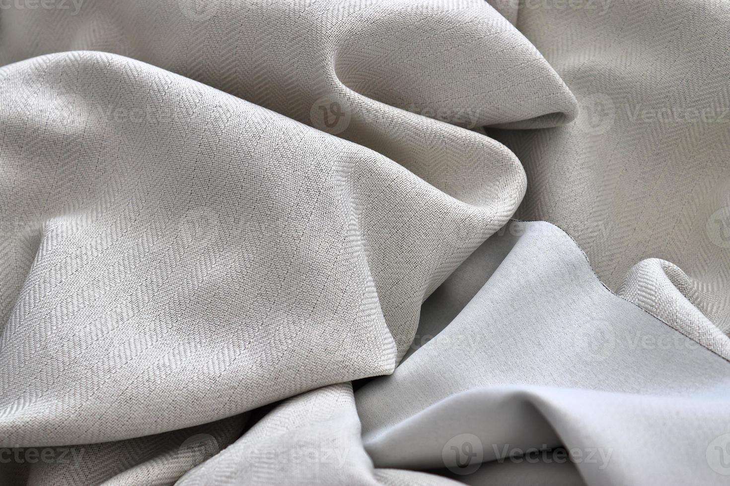 Detailed close up view on samples of cloth and fabrics in different colors found at a fabrics market photo