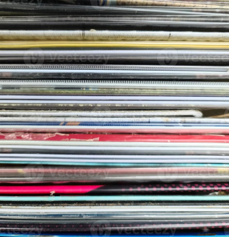 Numerous vintage signs and vinyl records in a box seen from above. photo