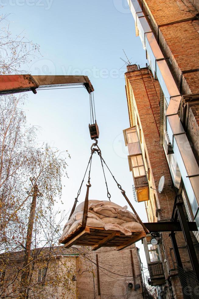 Loading sandbags for the renovation of an apartment in a five-story building photo