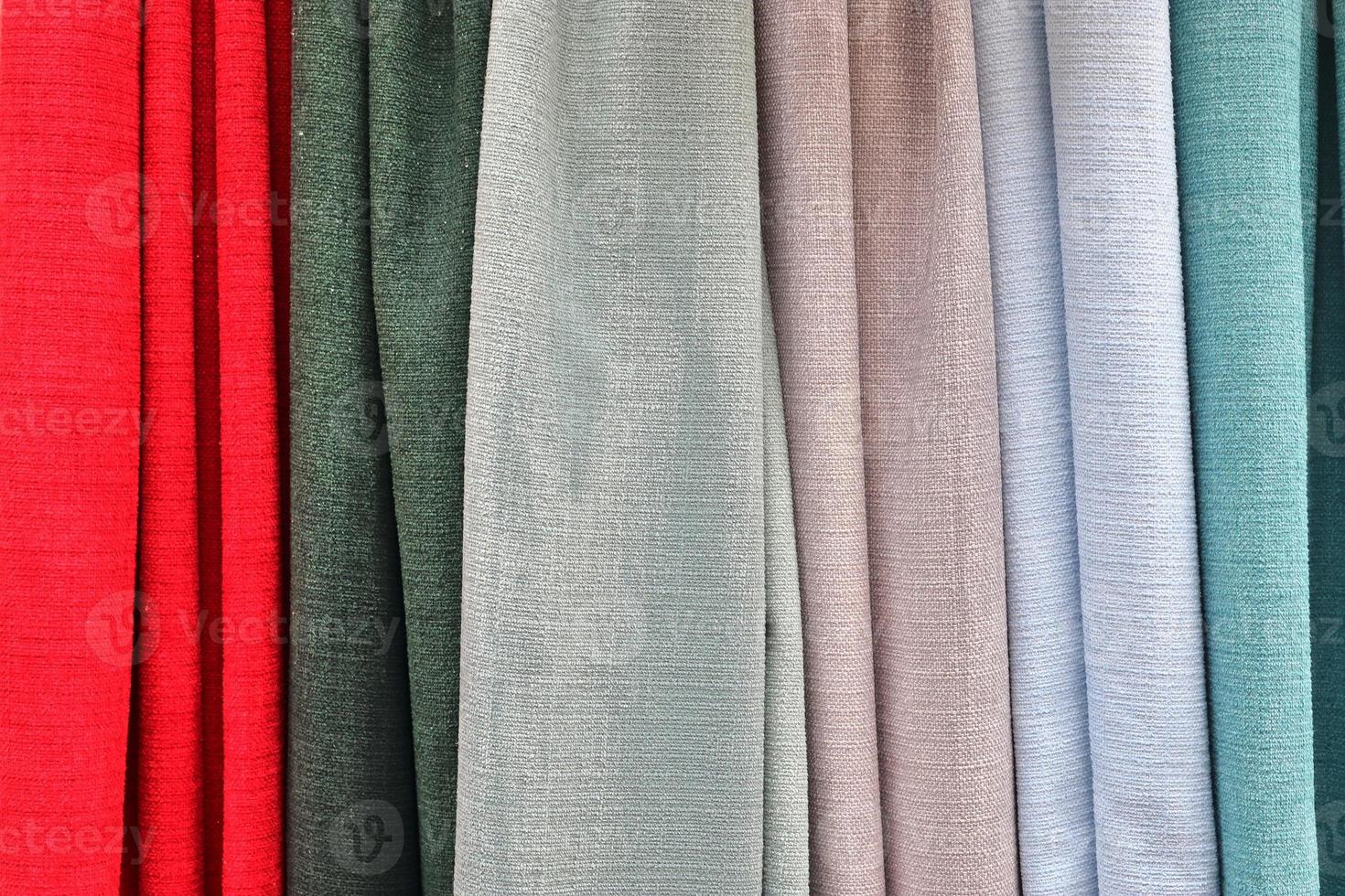 Detailed close up view on samples of cloth and fabrics in different colors found at a fabrics market photo
