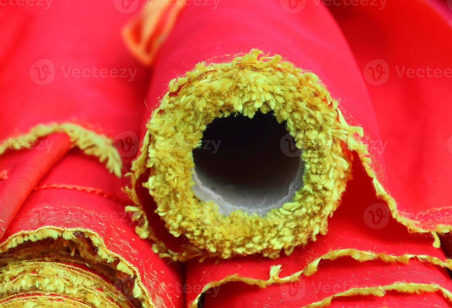 Detailed close up view on samples of cloth and fabrics in different colors found at a fabrics market photo