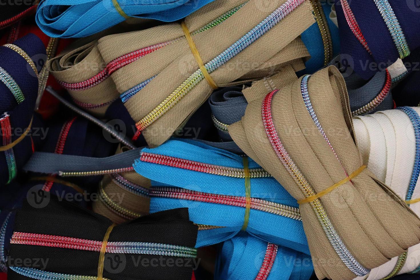 Detailed close up view on samples of cloth and fabrics in different colors found at a fabrics market photo