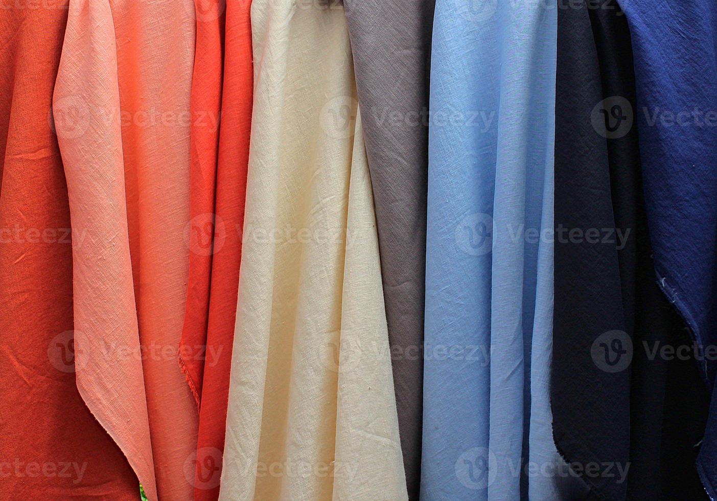 Detailed close up view on samples of cloth and fabrics in different colors found at a fabrics market photo