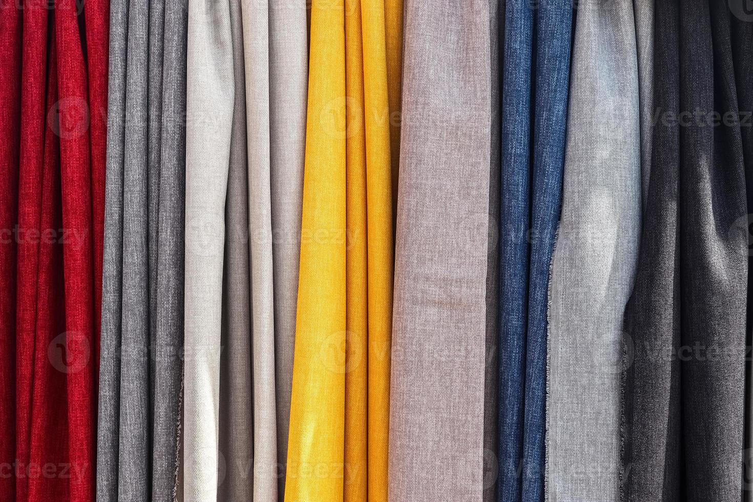 Detailed close up view on samples of cloth and fabrics in different colors found at a fabrics market photo