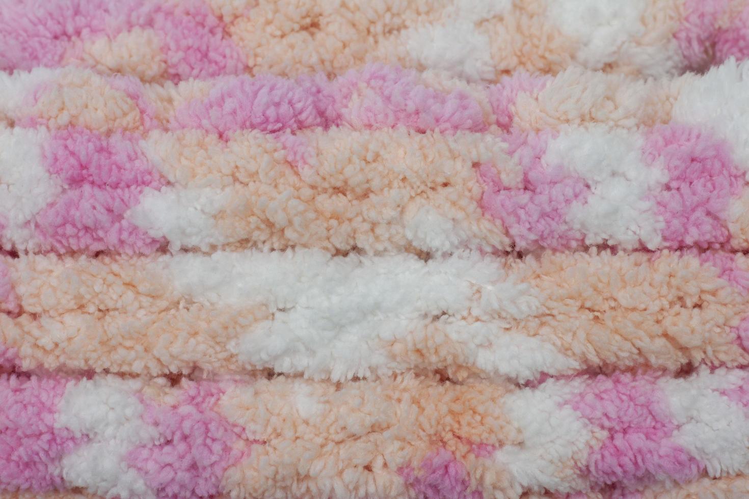Hand made crochet pattern of a colorful sheep wool yarn for background. photo