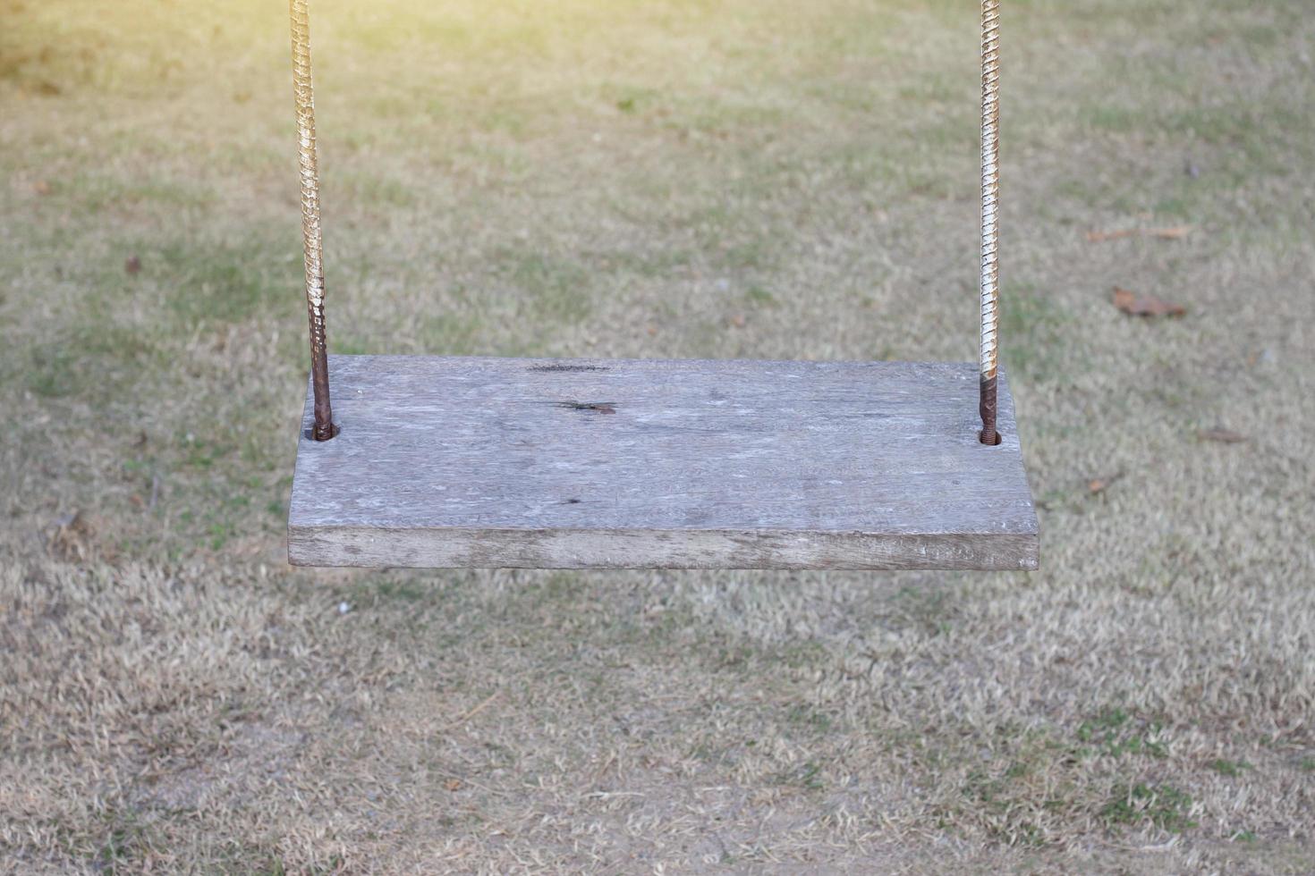 Empty swings on the countryside playground. photo