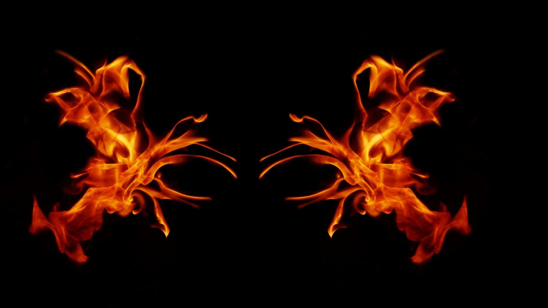 A beautiful flame shaped as imagined. like from hell, showing a dangerous and fiery fervor, black background. photo