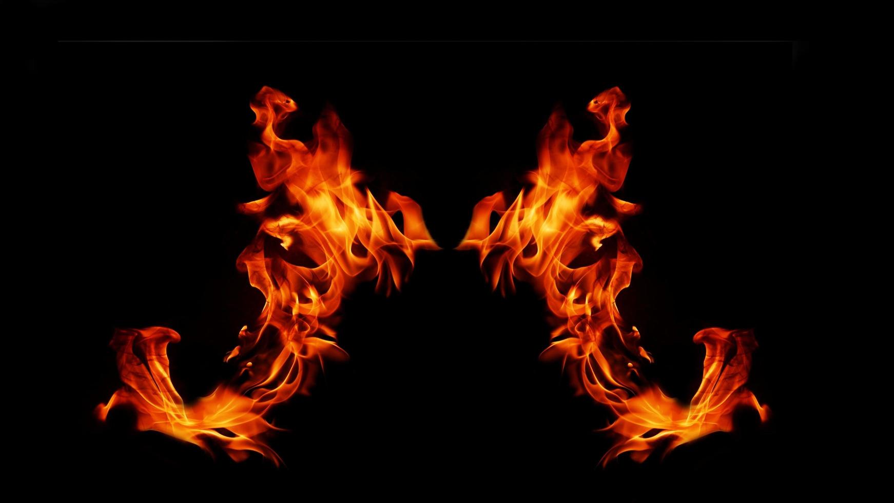 A beautiful flame shaped as imagined. like from hell, showing a dangerous and fiery fervor, black background. photo