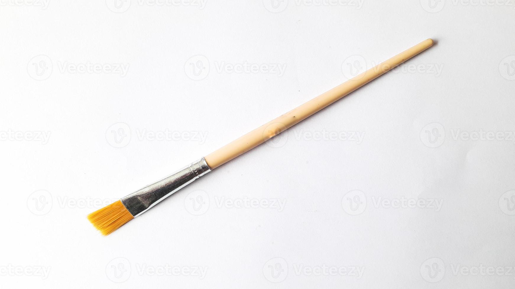 Top view of a variety of artist brushes on a white background with copy space for text. Creative postcard photo