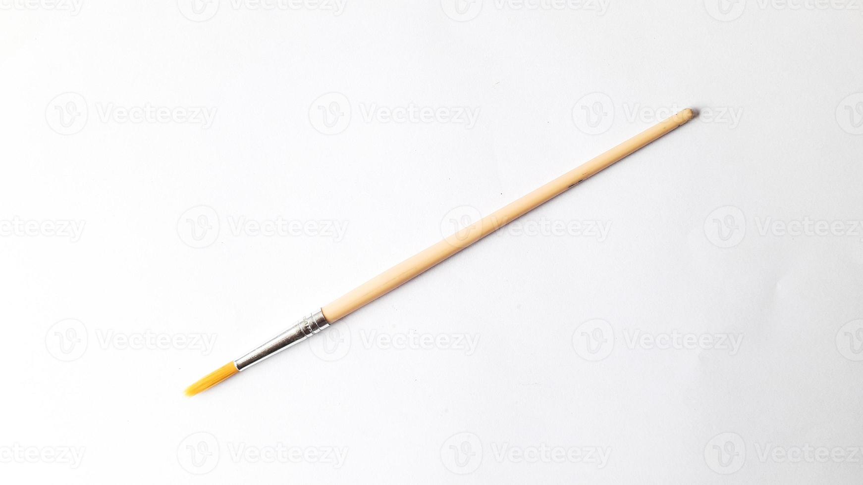 Top view of a variety of artist brushes on a white background with copy space for text. Creative postcard photo