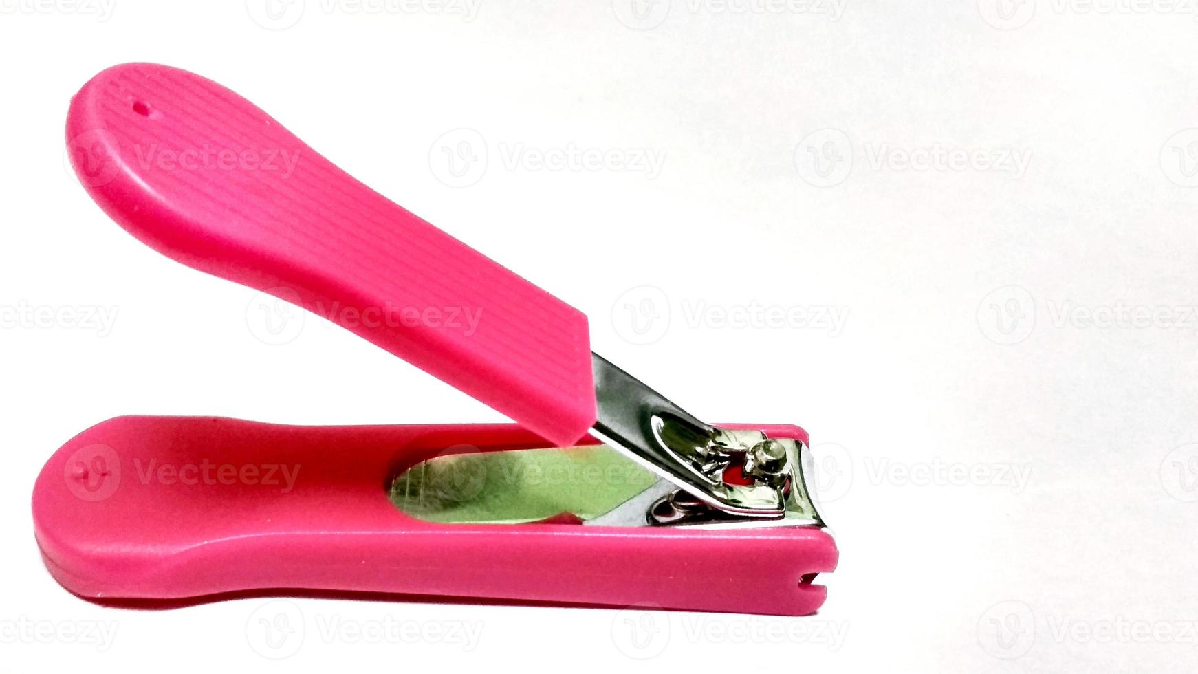 pink nail clipper on white background photo