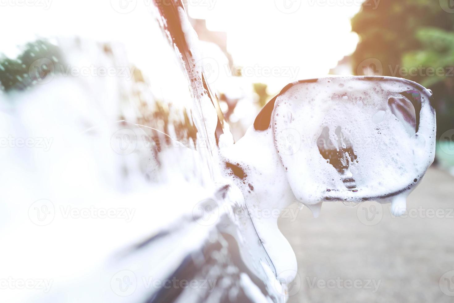 Outdoor car wash foam and soap on black background. abstract pattern , Banner Background Concept. Car Washing and Cleaning Backdrop with Copy Space. photo
