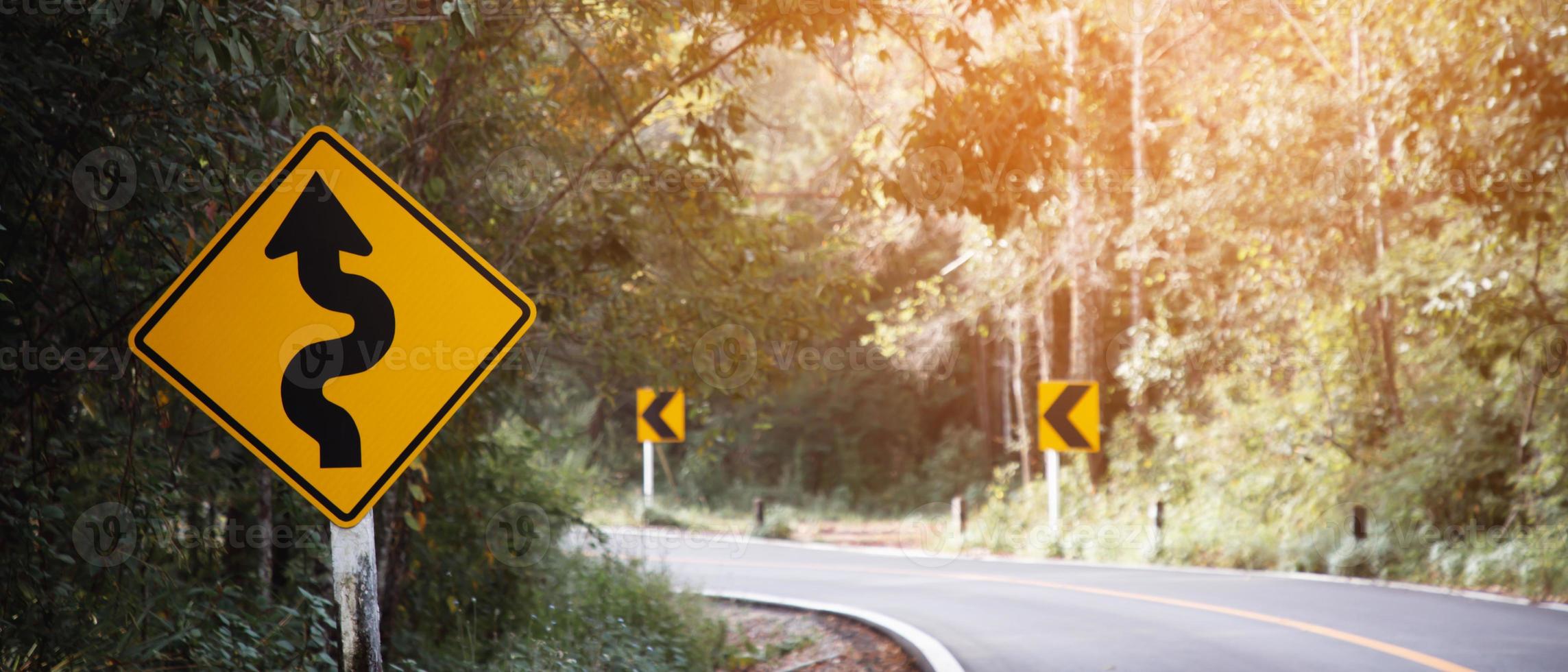 Traffic sign Dangerous curve on the road photo