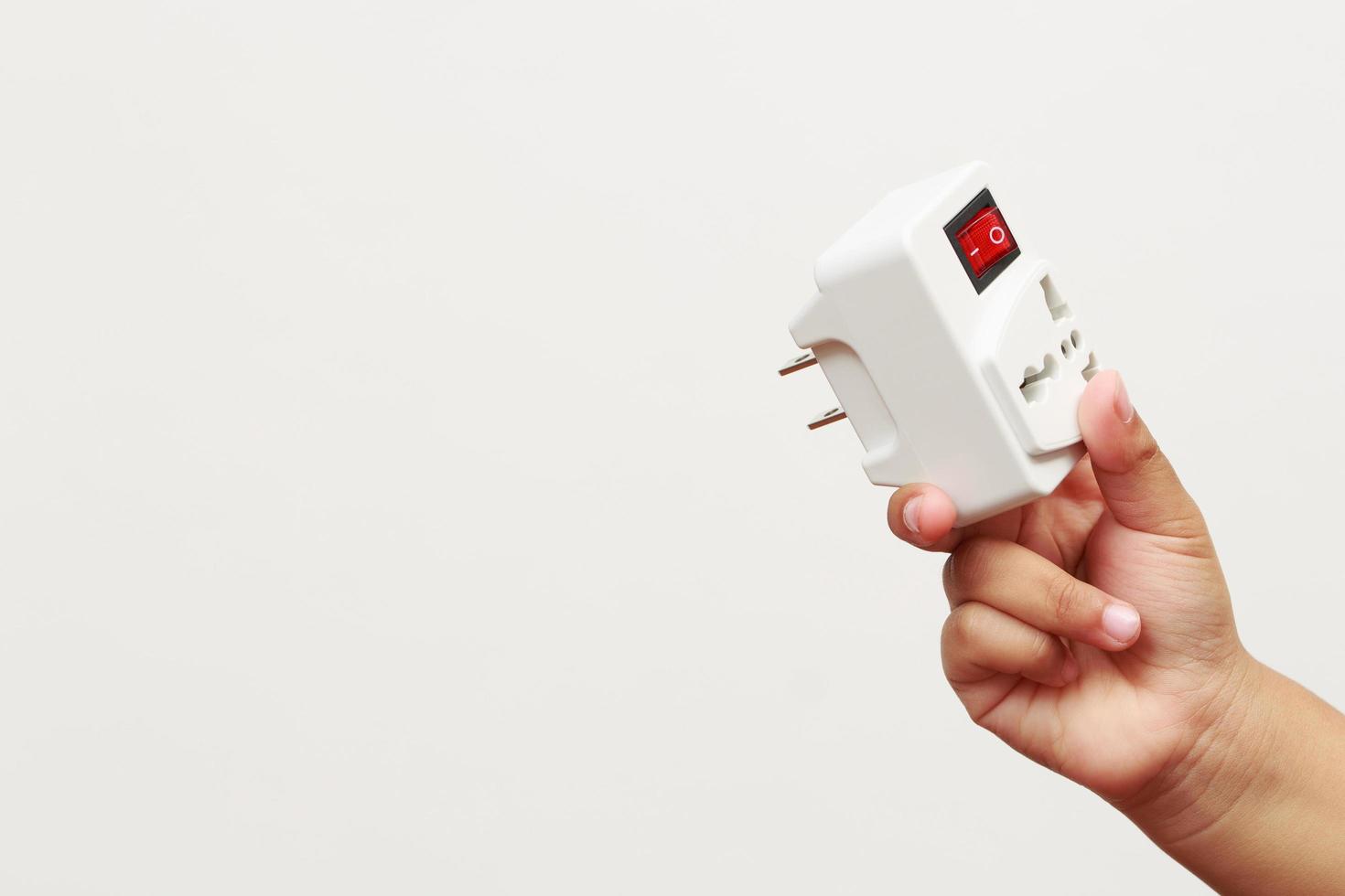 An extension socket is a device that consists of several components, such as a power cord, an electrical socket, an outlet, a power strip, and an electrical switch. photo