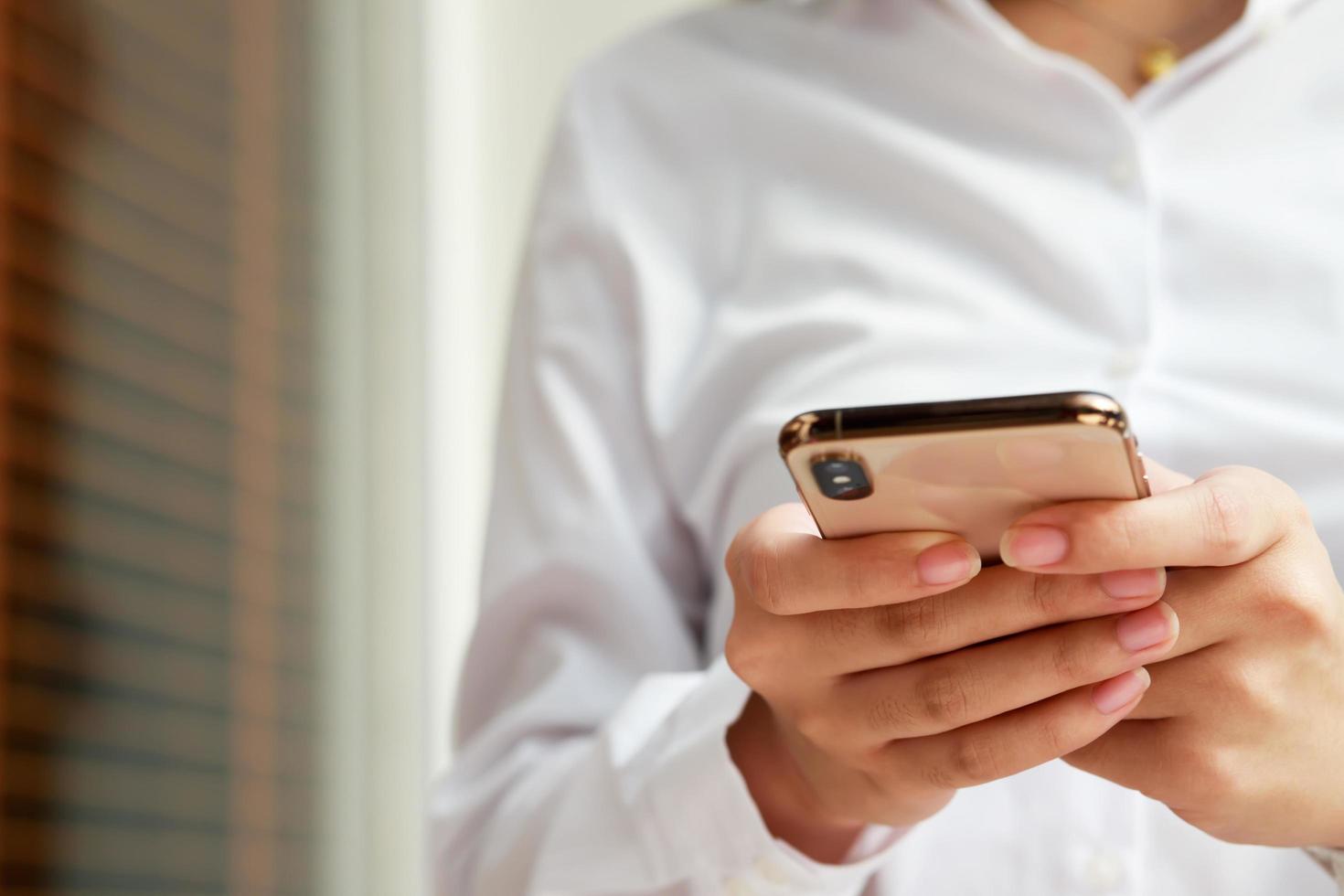 close up hand young woman in watching message on mobile smart phone during break. using cell phones to communicate in the online world. with blank or empty black screen photo