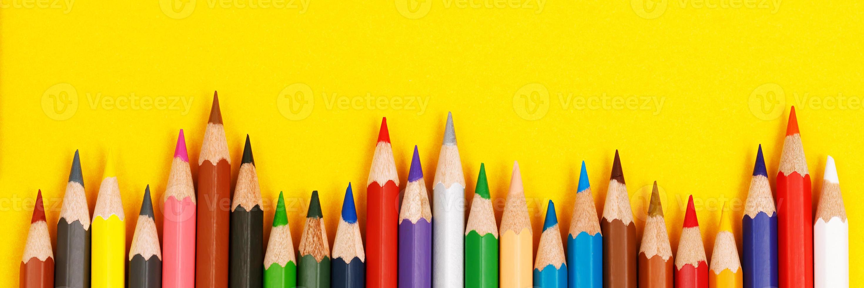 Close up of color pencils pile pencil tipped nibs put lined on the desk wooden. idea education back to school concept. Leave copy space empty for text. photo