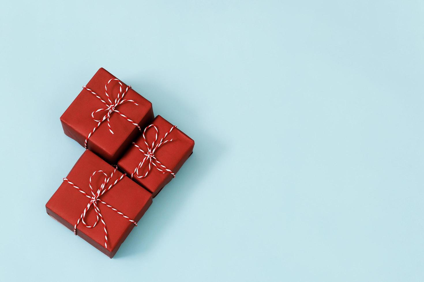 gift box red  new year Packed present container with ribbon on Vintage blue background for holiday concept with copy space, top view pattern. happy New Year photo