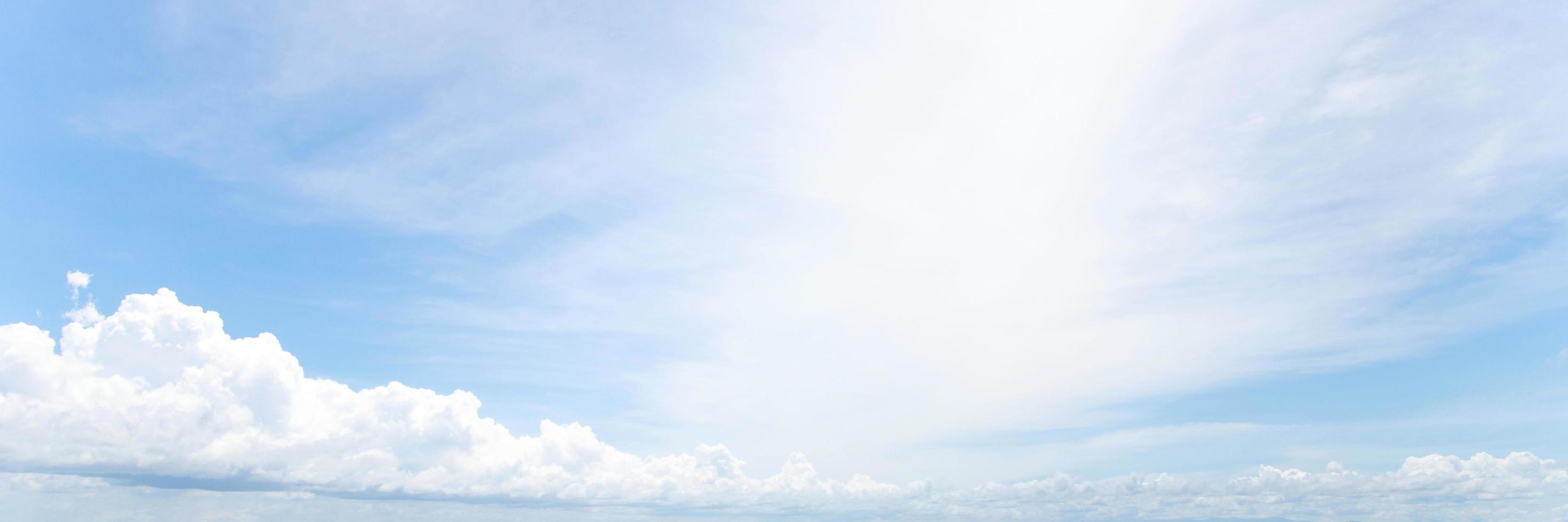 Beautiful clear blue sky background with tiny plain white cloud on morning time rays sunlight. space for text. soft focus. photo