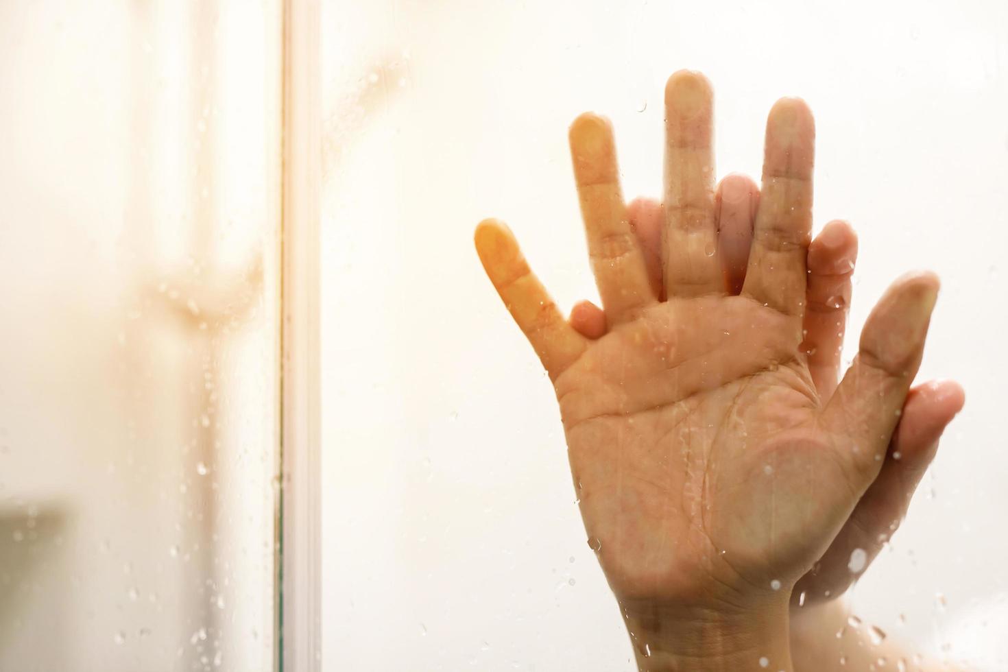 two male and female Couple lovers holding hands having sex inside showers bathroom mirror with a steamy window. soft focus.  Leave copy space empty to write text on the side. photo