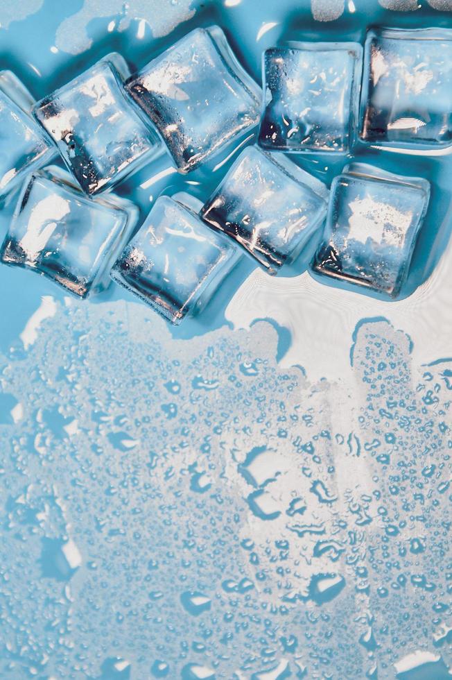 Ice cubes on studio blue background. The concept of freshness with coolness from ice cubes. photo