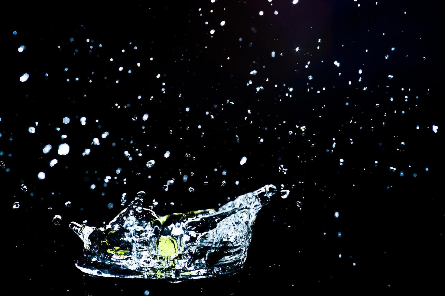 Scattered water splashes on a black background. water splash isolated on the black background photo