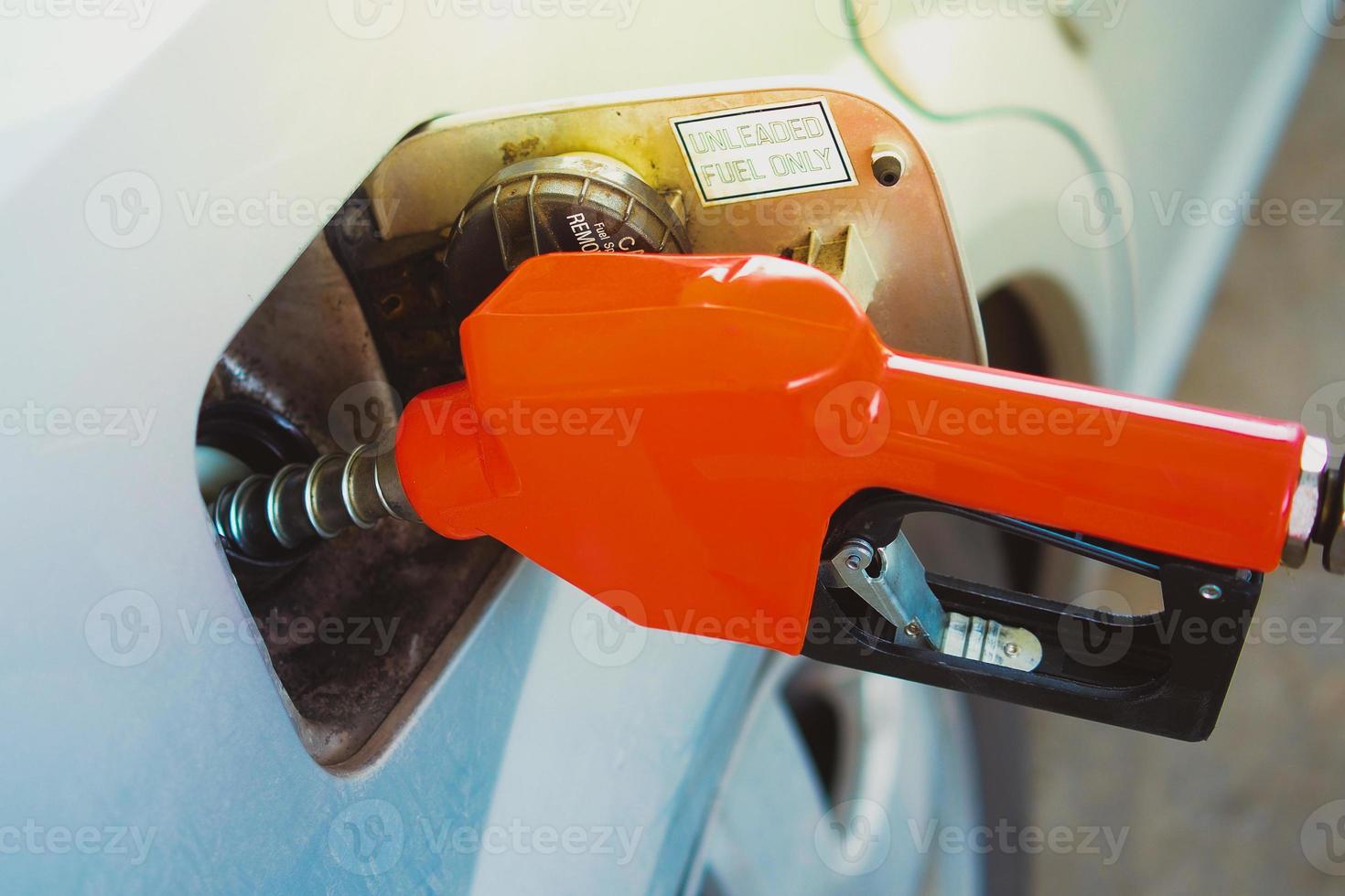 Gas station nozzles. Cars that are refueling in the gas station. The concept of fuel prices has changed. photo