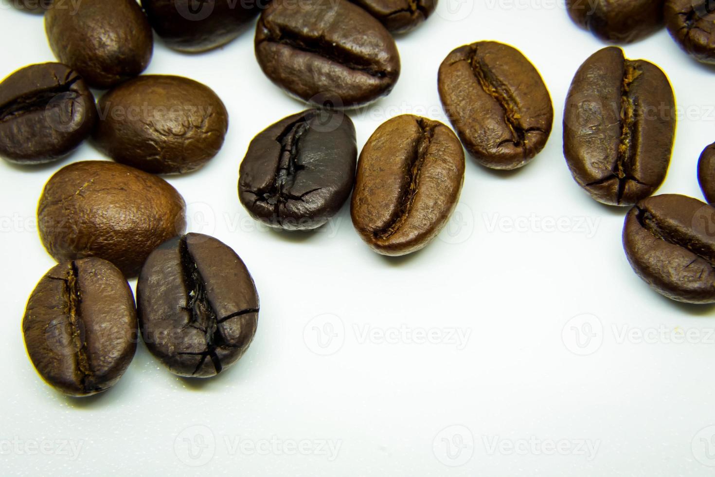 The way coffee beans lay on a white background, elegant and delicious coffee beans and the aroma of morning coffee. photo