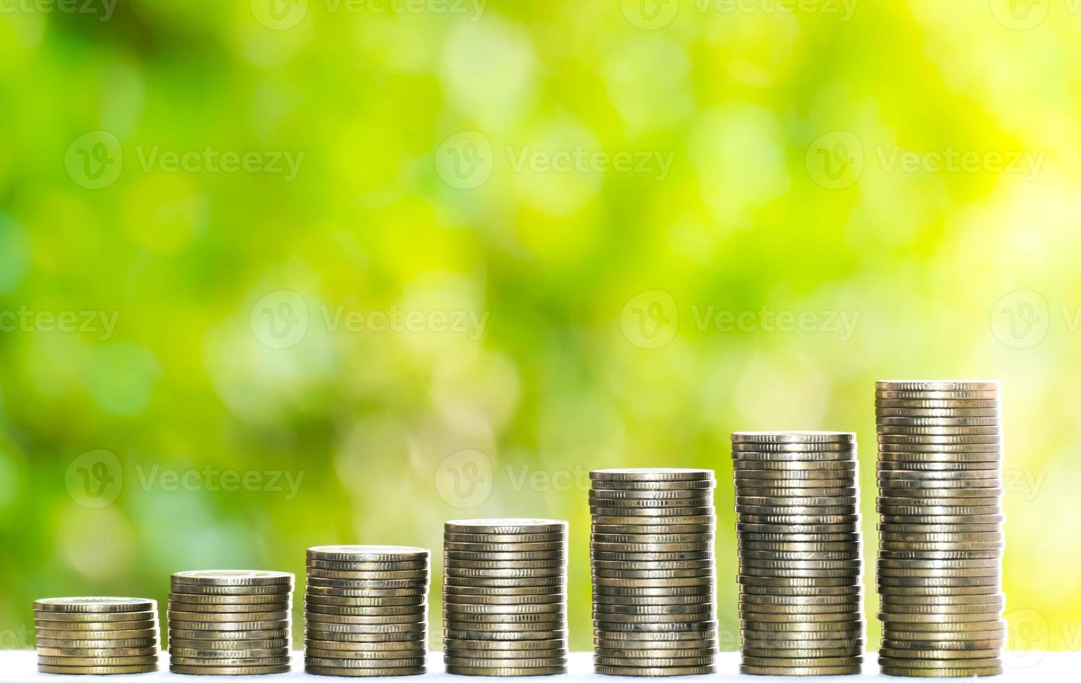 Business Finance and Money concept, Money coin stack growing graph with green tree bokeh background,investment concept photo