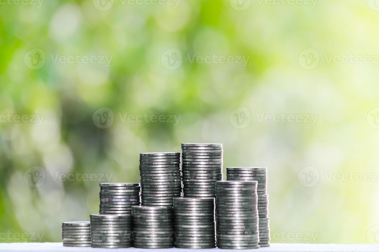 Business Finance and Money concept,Save money for prepare in the future.growing on coin of stacking Silver coins with green bokeh background photo
