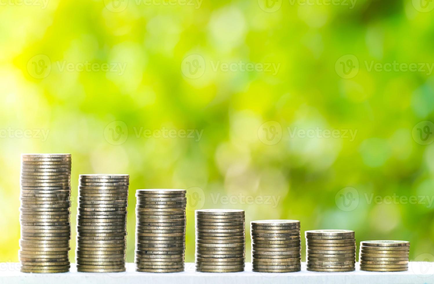 Business Finance and Money concept, Money coin stack growing graph with green tree bokeh background,investment concept photo