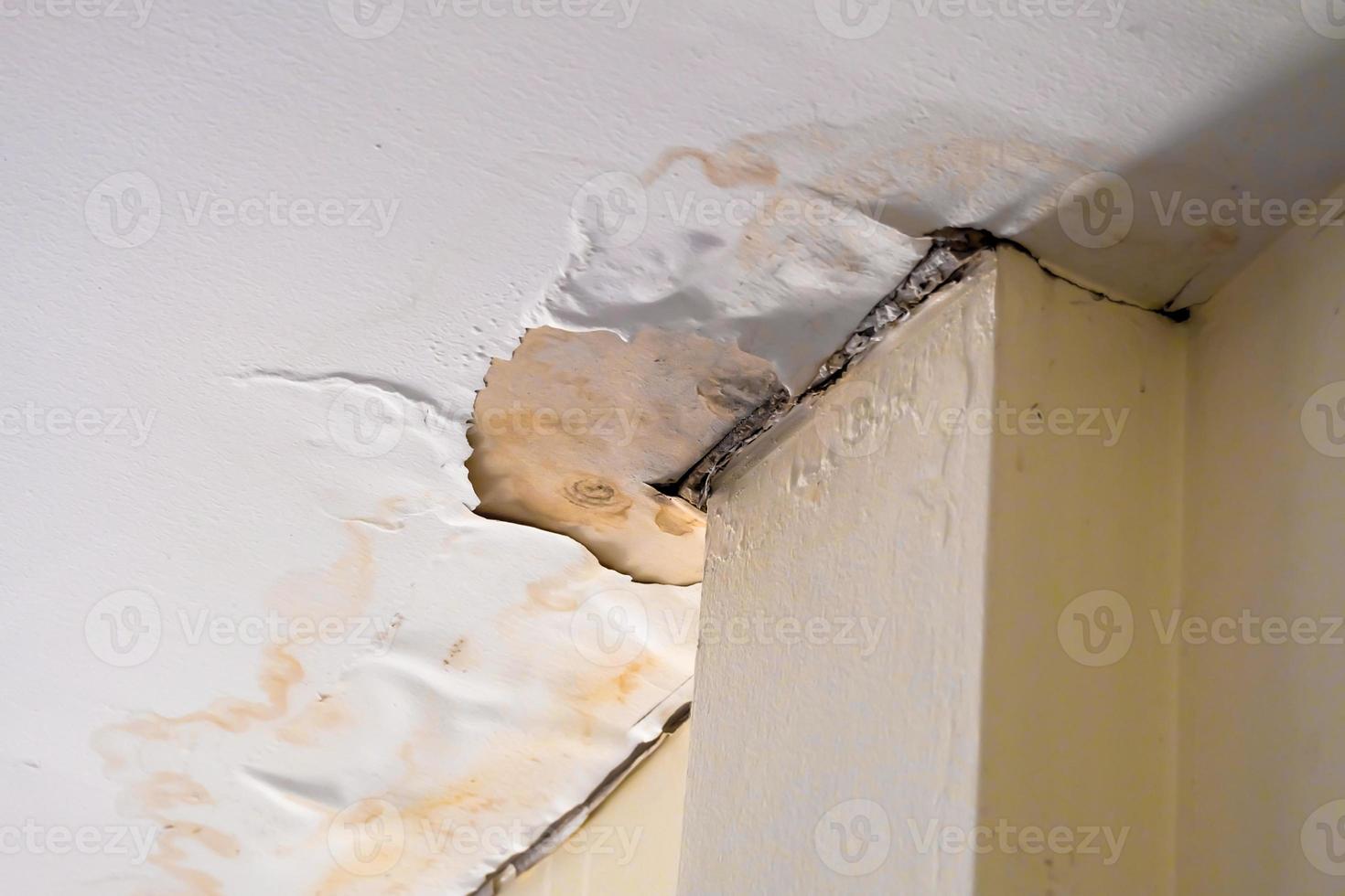 Water damaged ceiling  roof in an old abandoned house. photo