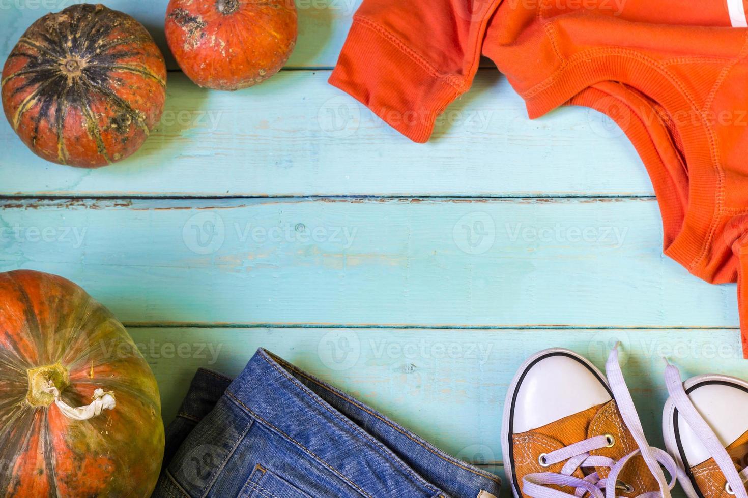autumn flat lay with pumpkin jeans sneakers sweatshirt photo