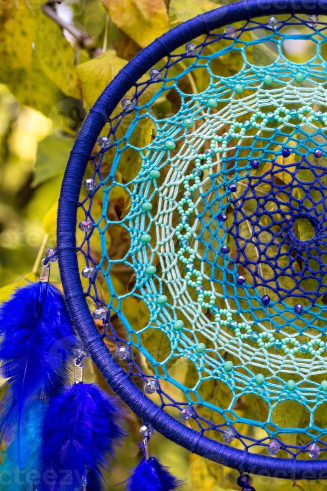 Handmade dream catcher with feathers threads and beads rope hanging photo