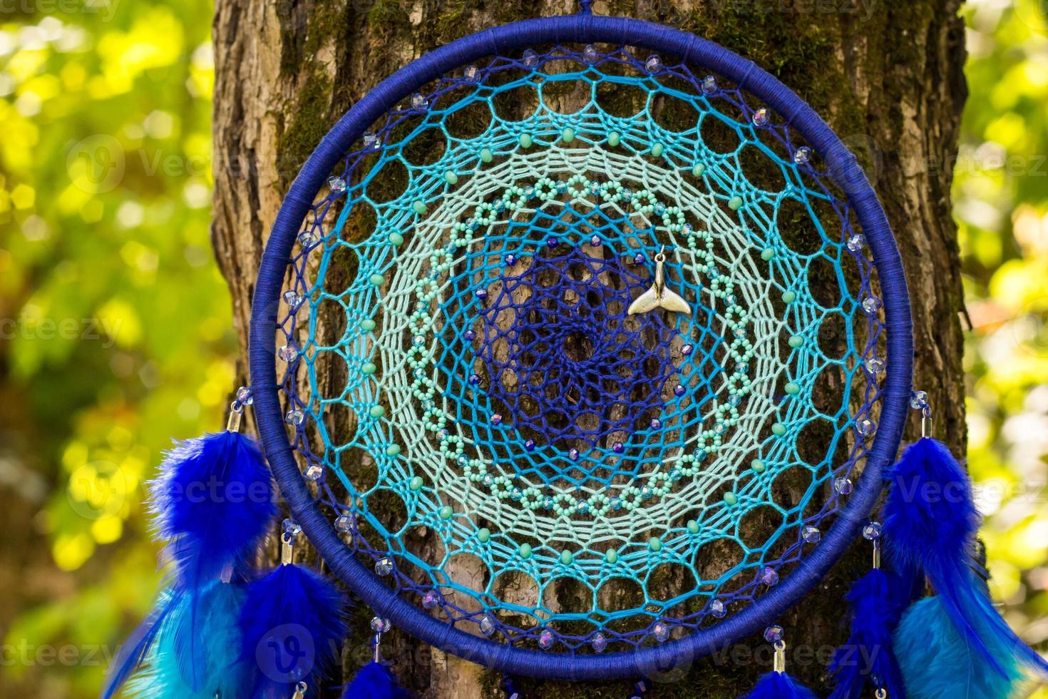Handmade dream catcher with feathers threads and beads rope hanging photo