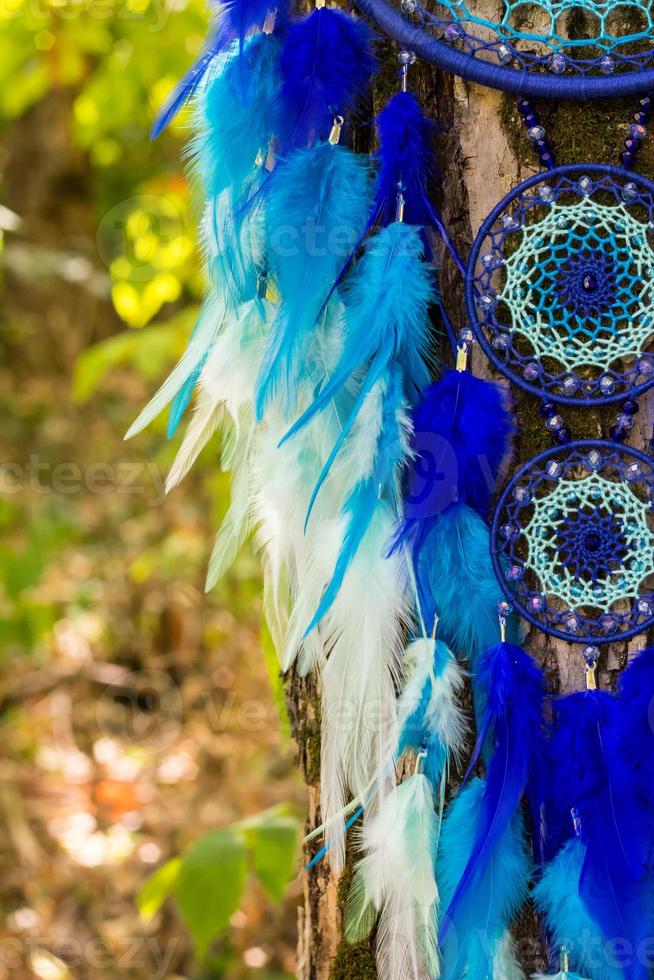 Handmade dream catcher with feathers threads and beads rope hanging photo