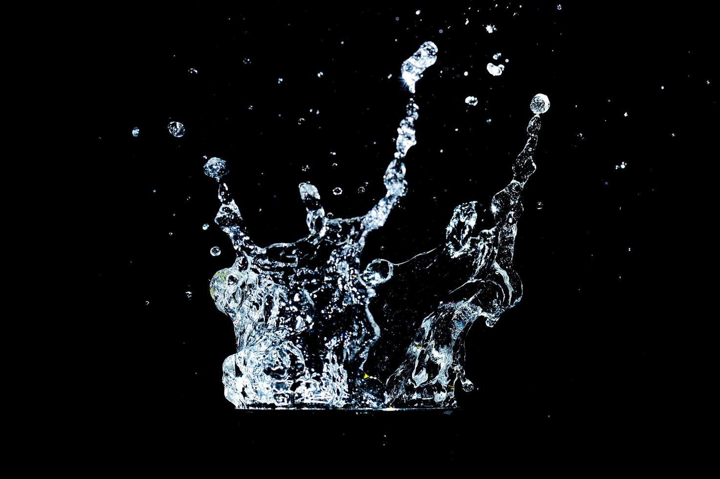 Scattered water splashes on a black background. water splash isolated on the black background photo