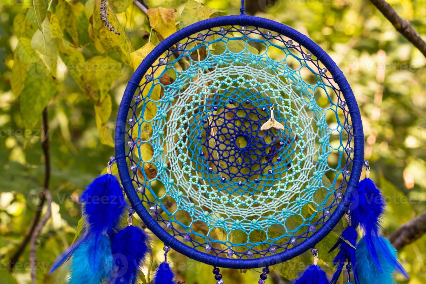 Handmade dream catcher with feathers threads and beads rope hanging photo