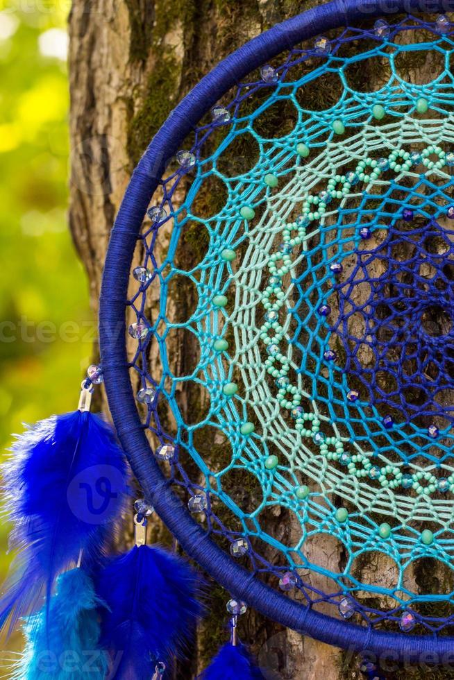 Handmade dream catcher with feathers threads and beads rope hanging photo
