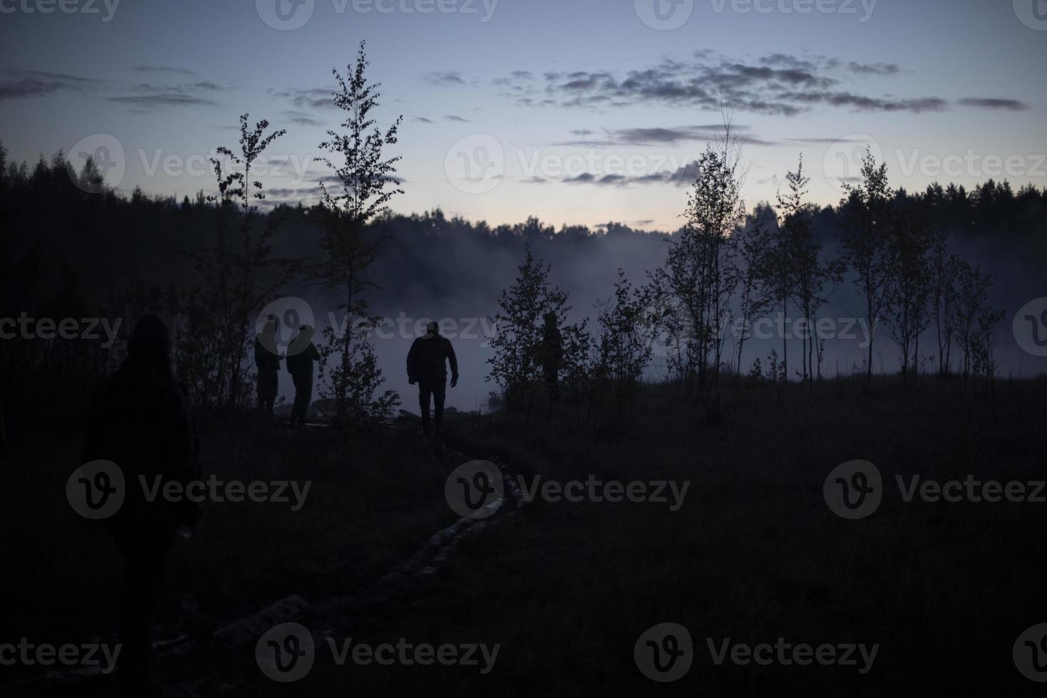 Man in fog on lake. Early morning in woods. photo