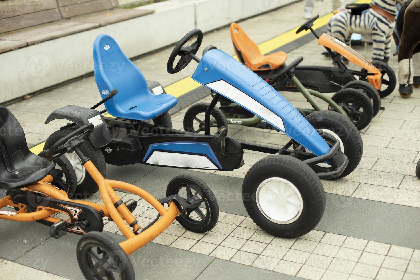 Children's transport in the park. Machines on a mechanical course. Entertaining bicycles for hire. photo