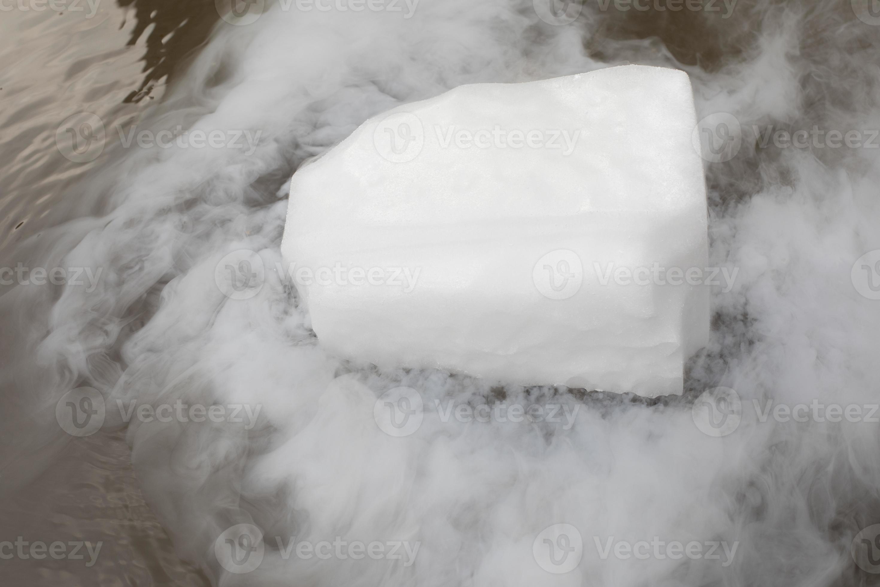 Dry ice evaporates in the water. Steam from a large piece of ice. Chemical experiment. 11347162