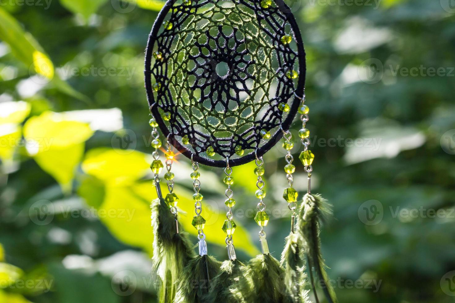Handmade dream catcher with feathers threads and beads rope hanging photo