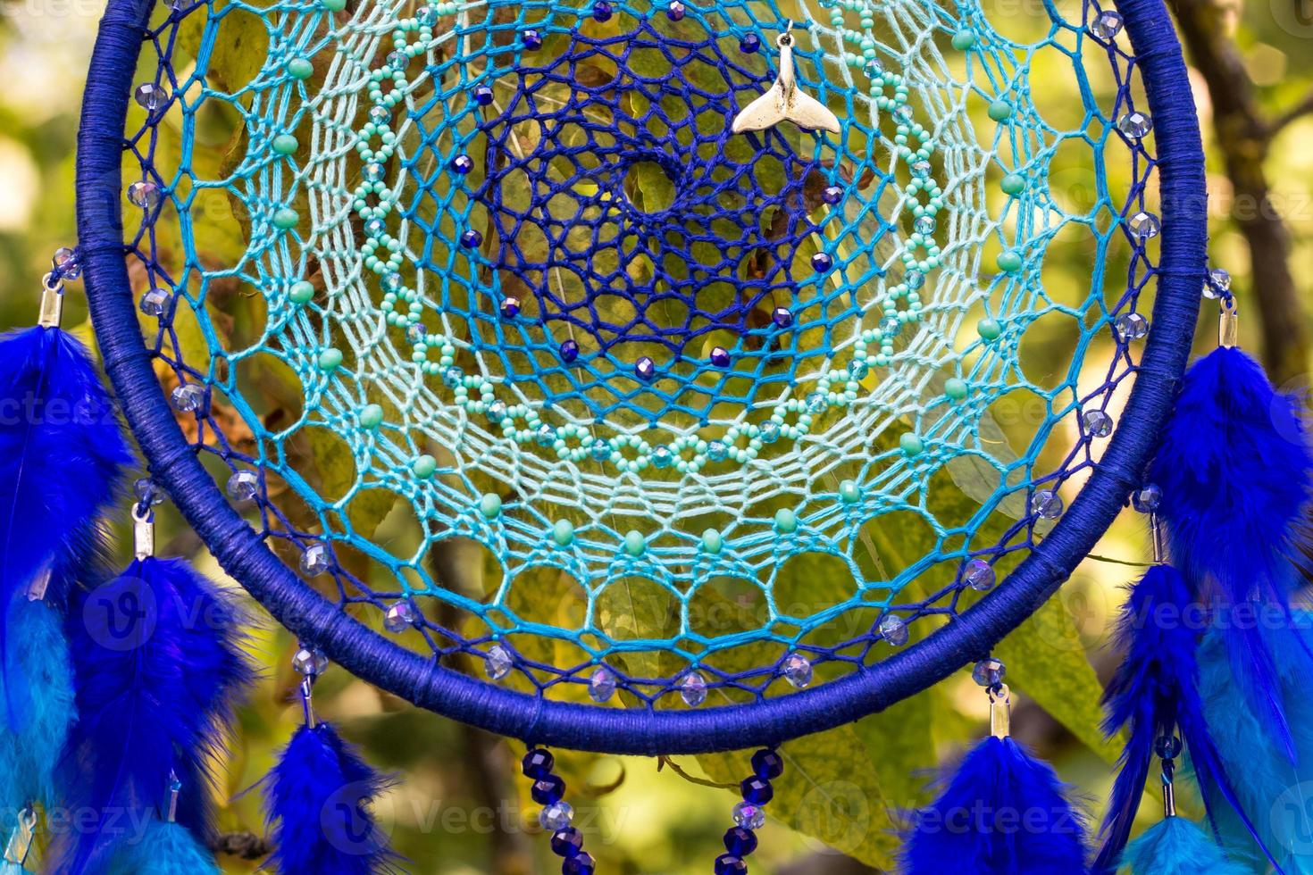 Handmade dream catcher with feathers threads and beads rope hanging photo
