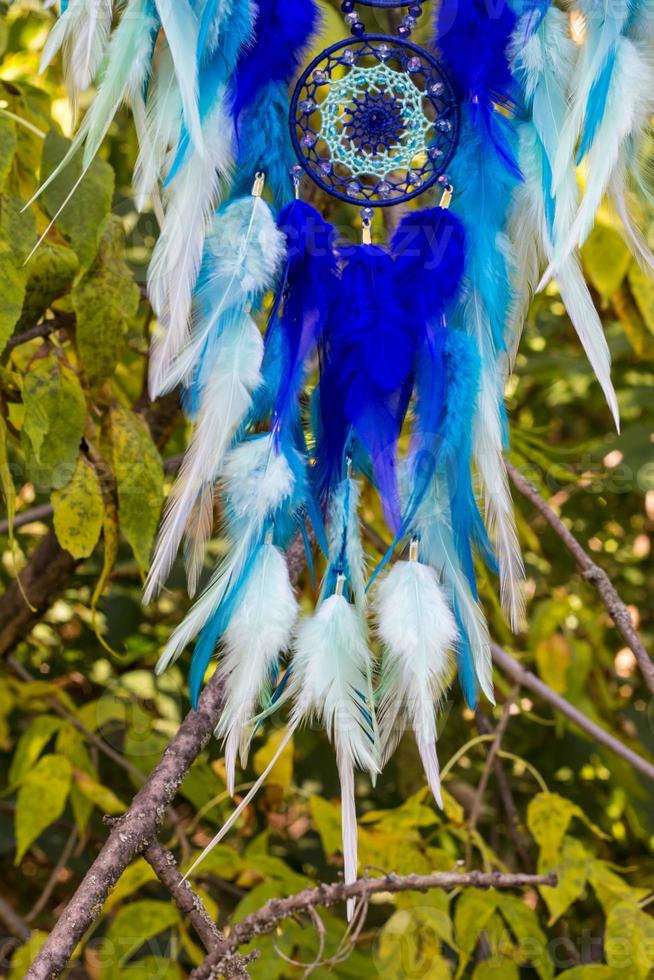 Handmade dream catcher with feathers threads and beads rope hanging photo