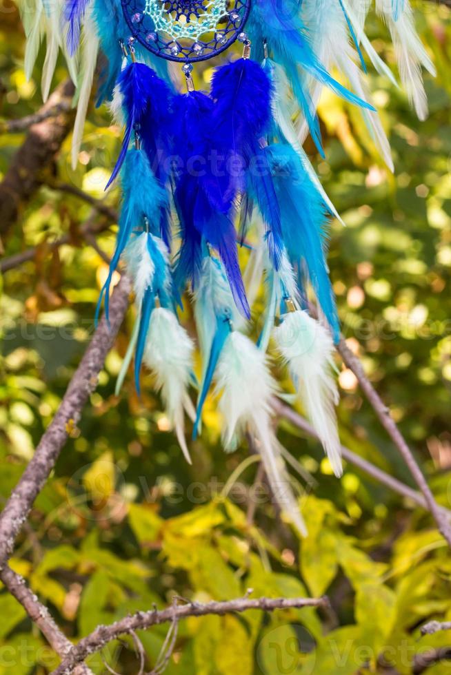 Handmade dream catcher with feathers threads and beads rope hanging photo
