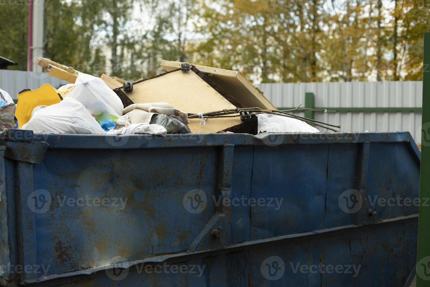 Container with garbage. Waste in the tank. photo