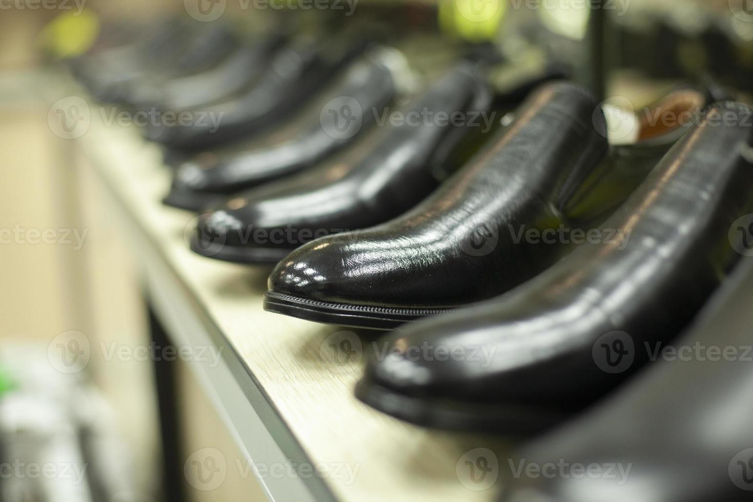 Black shoes in the store. Shoes are in a row. Lacquered shoes on sale. photo