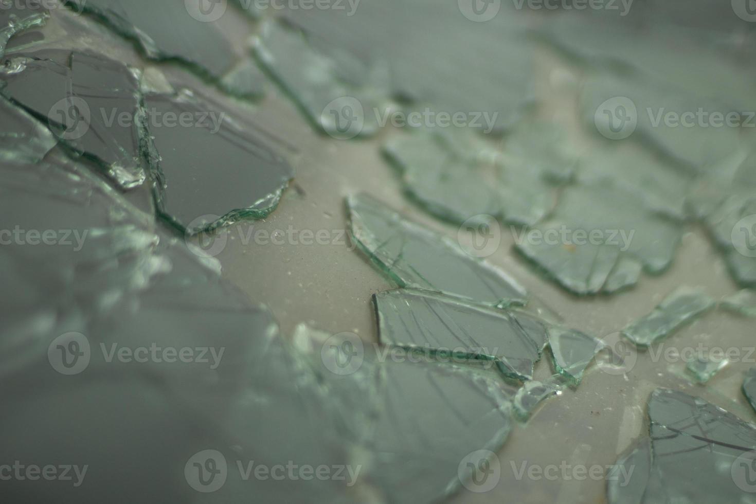 Broken glass in detail. Car windshield after the accident. Lots of small pieces. photo