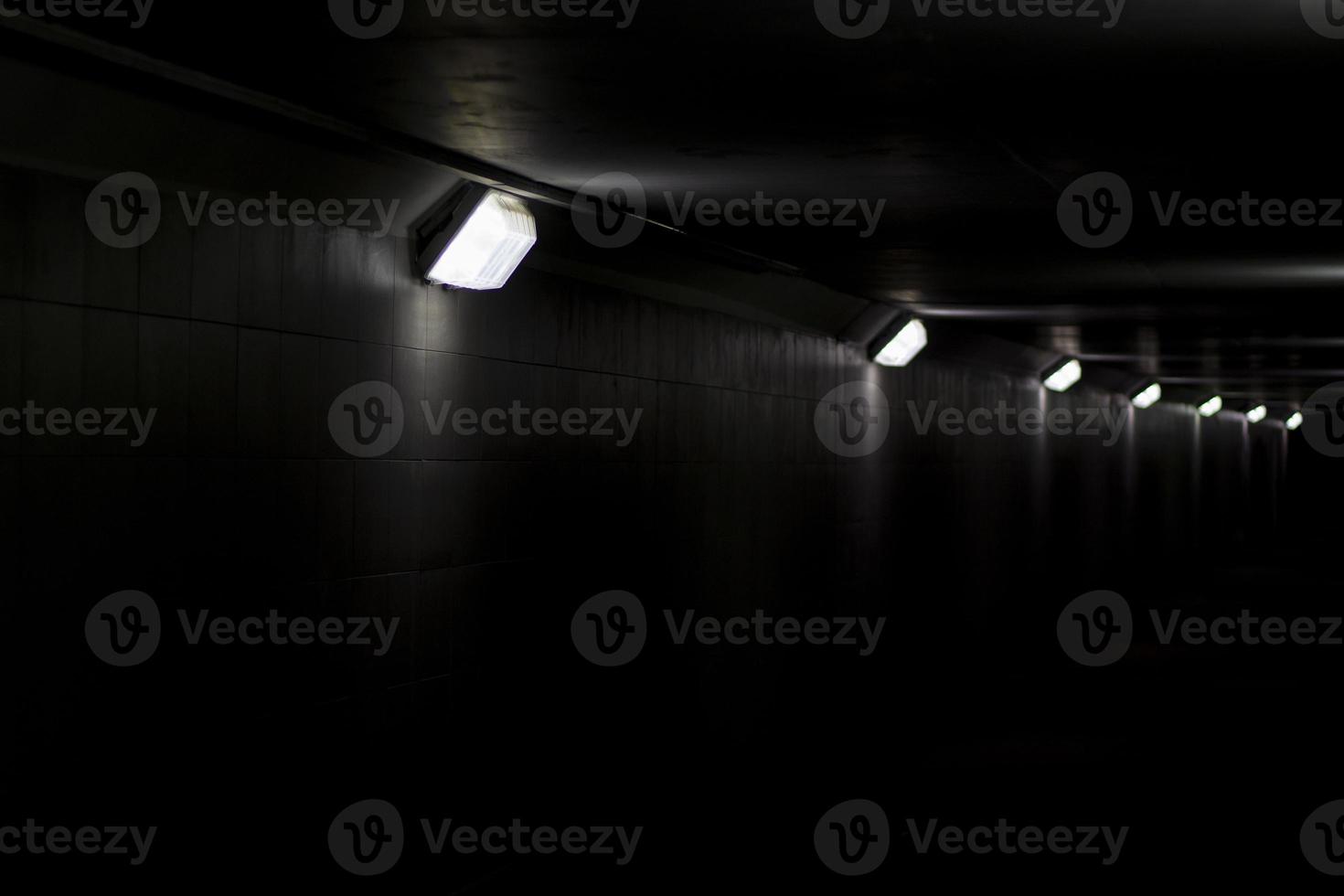 Lighting in the tunnel. Pedestrian crossing with lamps. LED light in a long tunnel under the track. photo
