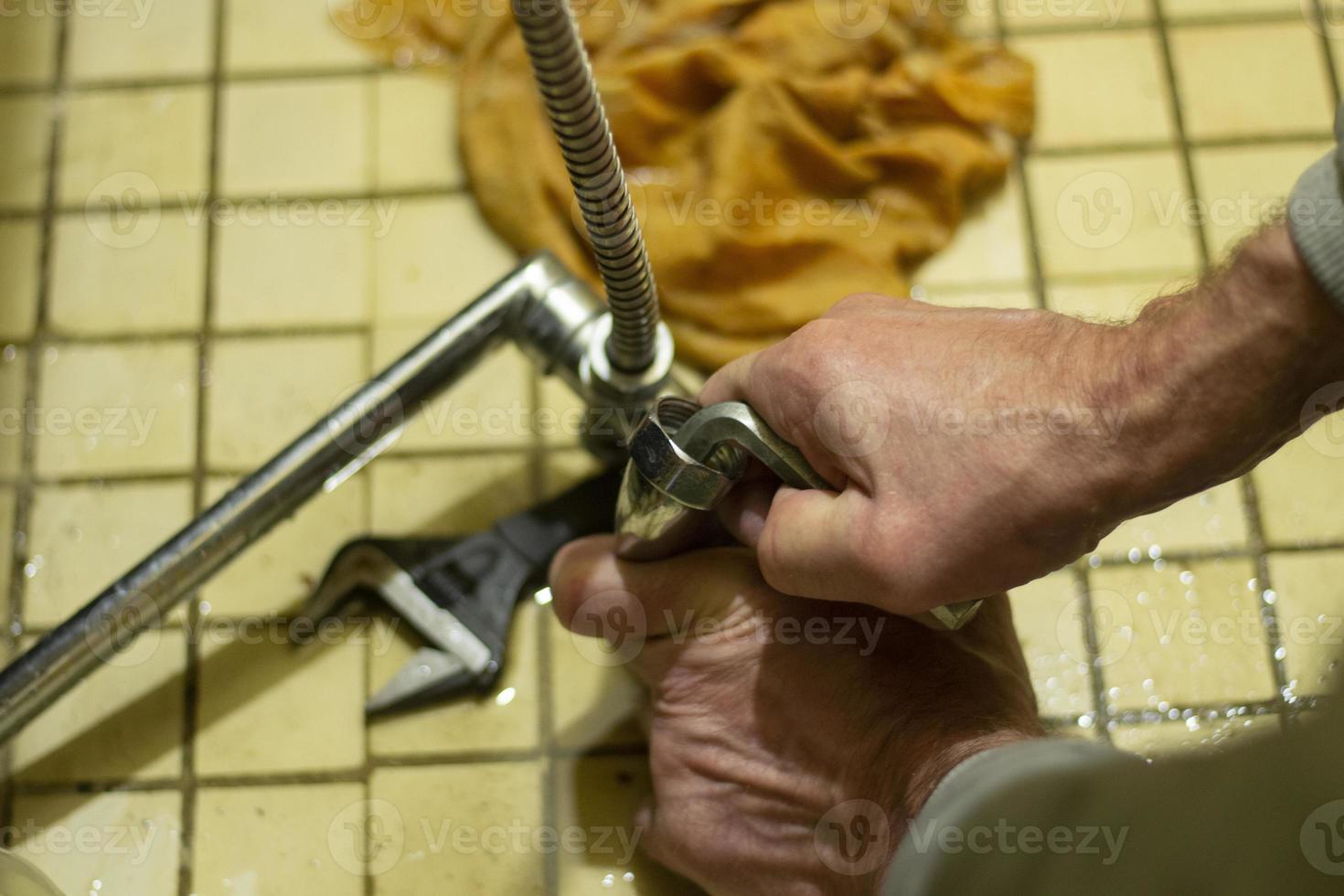 Repair of plumbing. Plumber repairs the faucet in Russia. photo